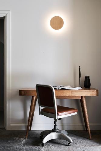 a wooden desk with a chair and a lamp at Hotel Ernest Bendigo in Bendigo