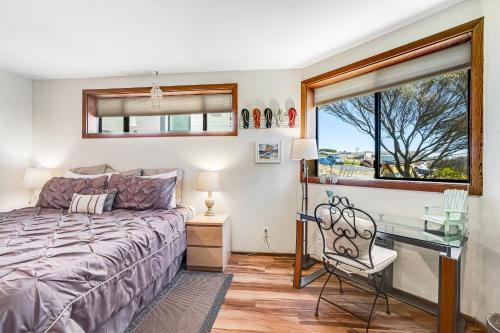 a bedroom with a bed and a desk and a window at Blue Horizon in Bodega Bay