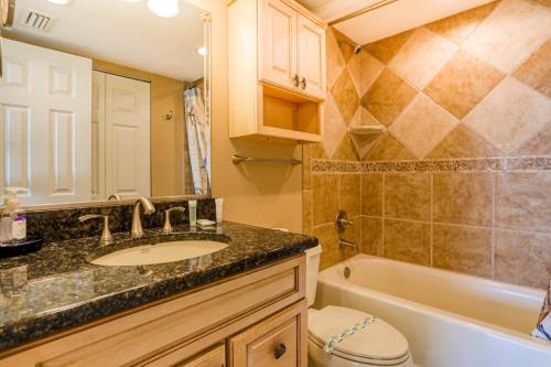 a bathroom with a sink and a tub and a toilet at Bay Oaks 75 in Siesta Key