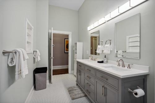 a white bathroom with a sink and a mirror at The Balcony House II in New Orleans
