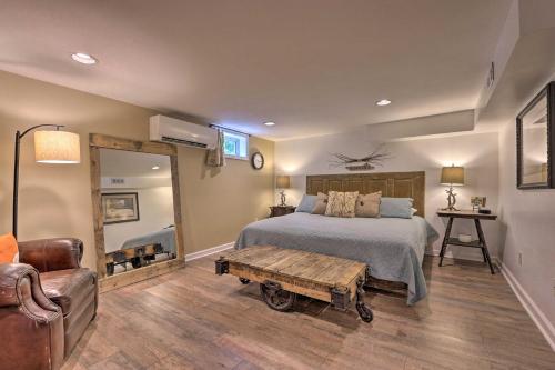 1 dormitorio con cama, mesa y espejo en Black Mountain Retreat - Fire Pit and Near Kayaking!, en Black Mountain