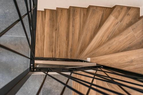 a room with a wooden floor and a wooden wall at Prima Countryside Apartments in Žirovnica