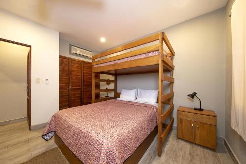 a bedroom with a bunk bed and a ladder bed at Newly Remodeled Ground-Floor Unit in Flamingo in Front of Beach in Playa Flamingo