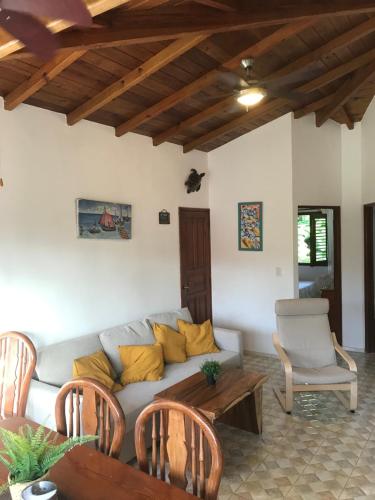 a living room with a couch and a table at La Cortesana Cozy Two Bedroom Apartment Steps to the Beach in Las Terrenas
