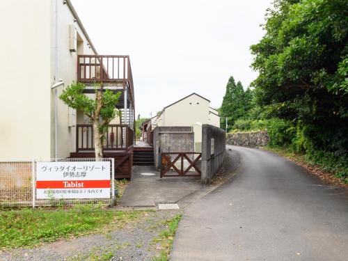 a road next to a house with a gate on the side at Tabist Villa Daio Resort Ise-Shima in Shima