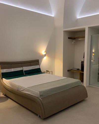 a bedroom with a large bed in a room at Anema e Core by Andrea de Carlo in Leverano
