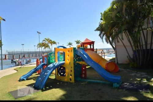 a playground with a slide on the beach at Lindo Apart Lake Side com banheira in Brasilia