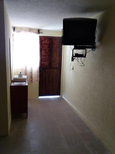 a room with a flat screen tv on the wall at HOTEL RESTAURANT LOS PRISMAS in Huasca de Ocampo