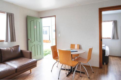 a living room with a table and chairs and a couch at BIG4 Ingenia Holidays Inverloch in Inverloch