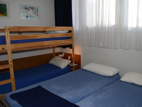 a bedroom with two bunk beds and a ladder at Appartement Flaine, 2 pièces, 6 personnes - FR-1-425-137 in Arâches-la-Frasse