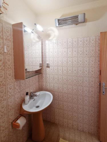 a bathroom with a sink and a mirror at Triple Room Vrboska 540e in Vrboska