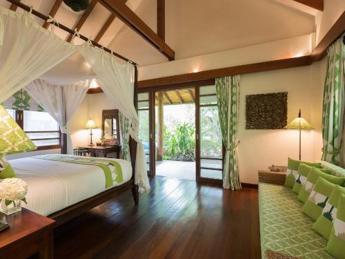a bedroom with a bed and a large window at Villa Waimarie - SHA Extra Plus in Lipa Noi