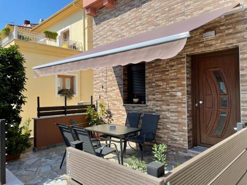 a patio with a table and chairs and a building at Felicia`s House in Agria