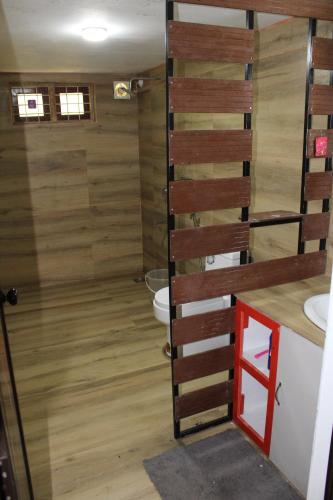 a bathroom with a toilet and a sink at ARABIAN HOLIDAY RESORT WITH SWIMMING POOL IN IDUKKI Calvary Mount in Idukki