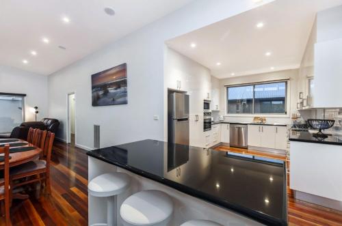 a kitchen and dining room with a large counter top at Shore Shanks in Port Fairy