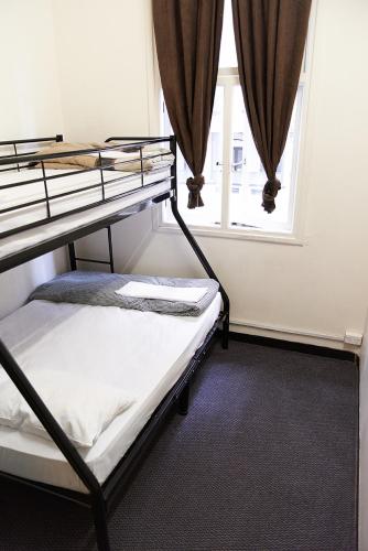 a bedroom with two bunk beds and a window at Maze Backpackers - Sydney in Sydney