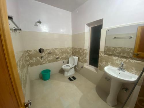 a bathroom with a toilet and a sink at Otsal guest house nubra in Deskit