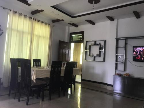 a dining room with a table and chairs at SWAT HiLL ViEW RESORT-only for families in Swat