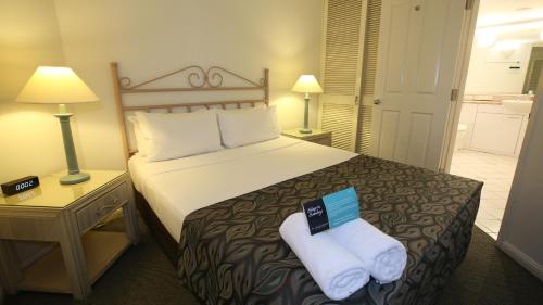 a hotel room with a bed and a desk at Il Palazzo Holiday Apartments in Cairns