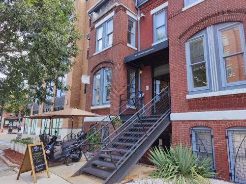 a brick building with a staircase in front of it at U Street Capsule Hostel in Washington