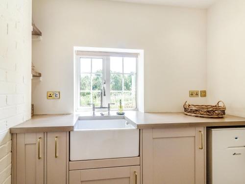 a kitchen with a sink and a window at Ivet Lowe in Matlock