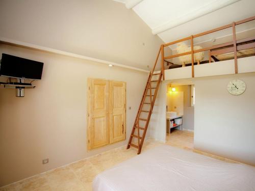 a bedroom with a bunk bed and a ladder at Villa in Provence with Infinity Pool in Martres-Tolosane