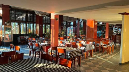 a dining room with tables and chairs in a restaurant at Hotel Emka in Tetovo