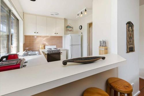 a kitchen with a counter with a bowl on it at Cosy Back Beach Hideaway with Fire Pit. in Portsea