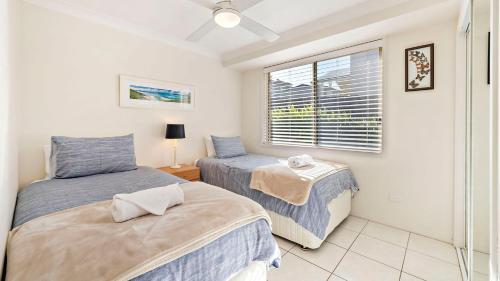a bedroom with two beds and a window at My Shell Boat Harbour 55 Blanch Steet in Boat Harbour