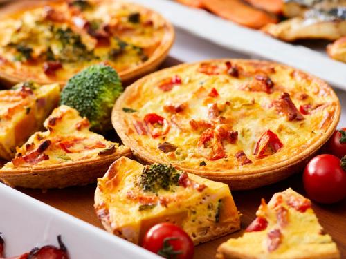 a group of pizzas in a box on a table at Hotel Metropolitan Saitama-Shintoshin in Saitama