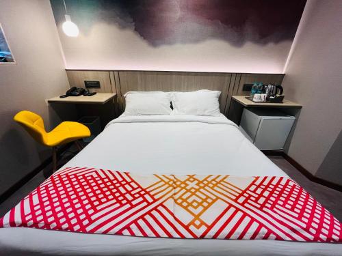 a bedroom with a bed with a red and white blanket at Ginger Mumbai, Goregaon in Mumbai