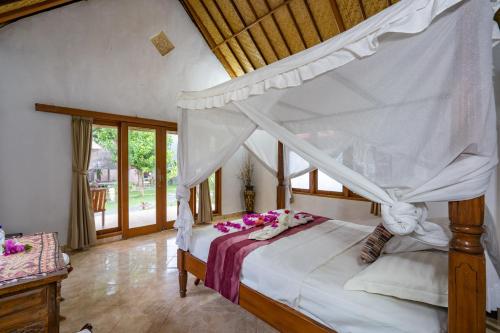 Ένα ή περισσότερα κρεβάτια σε δωμάτιο στο Mushroom Beach Bungalows