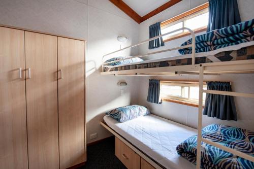 a room with two bunk beds and a window at Wallaroo Beachfront Tourist Park in Wallaroo