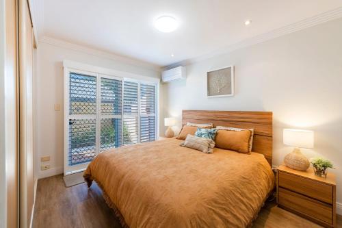 a bedroom with a large bed and a window at Riverview Apartments 2 3 Building 2 Unit 3 in Iluka