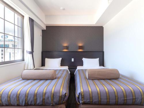 Katil atau katil-katil dalam bilik di Hotel Koza