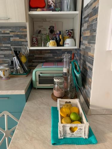 a box of fruit sitting on a floor in a kitchen at Eve Home Suite Home in Nettuno