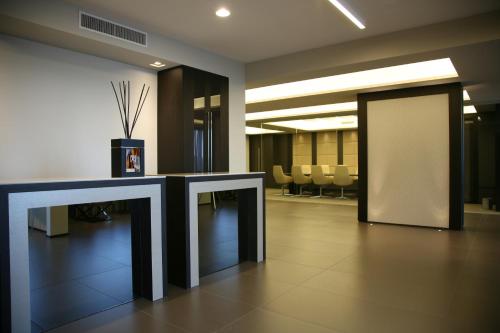 a lobby with a table and chairs in a building at Ego Hotel in Ancona