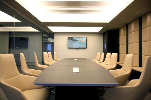 a conference room with a long table and chairs at Ego Hotel in Ancona