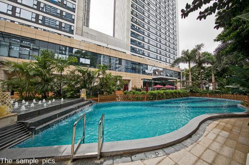 a large swimming pool in front of a building at Shenzhen FY Hotel in Shenzhen