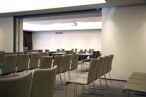 a conference room with tables and chairs in it at Ego Hotel in Ancona