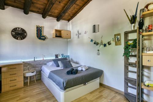 a bedroom with a bed and a clock on the wall at El paller in Borrassá