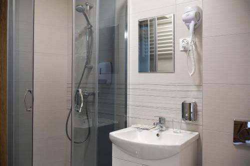 a bathroom with a shower and a sink and a shower at Royal Gdansk in Gdańsk