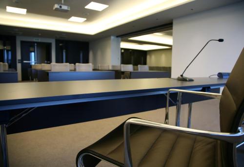 a conference room with a table and a chair at Ego Hotel in Ancona
