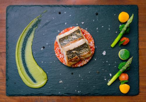 a plate with a piece of sushi and a banana at Nova Maldives in Dhangethi