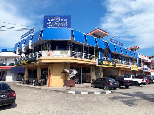 a large building with a sign on top of it at AE Semporna Guesthouse 极潜旅店 in Semporna