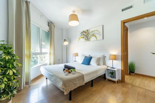 a bedroom with a bed and a large window at Valparaiso Premium Playa Apartment with parking in Málaga