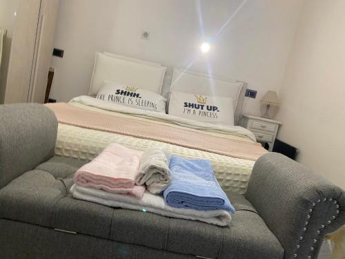 a bedroom with a bed with towels on a couch at Eve Home Suite Home in Nettuno