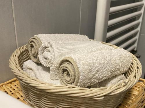 a basket filled with towels in a bathroom at Eve Home Suite Home in Nettuno