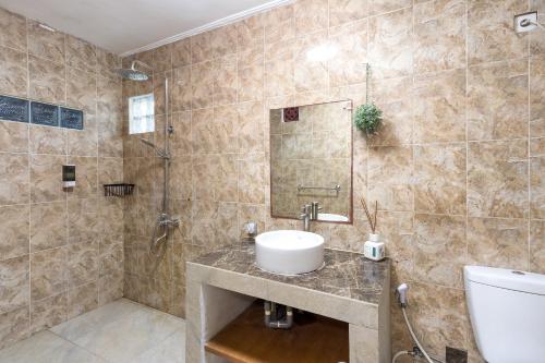 a bathroom with a sink and a shower at Villa Yati in Seminyak