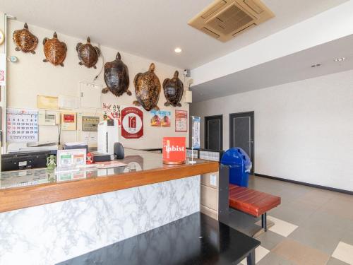 a bar in a restaurant with a counter at Tabist Izumi Yusen Shukuhaku Center in Izumi